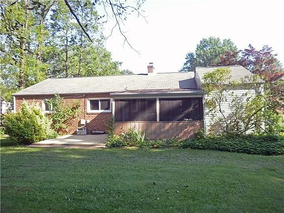 Rear view of home with patio & screened porch