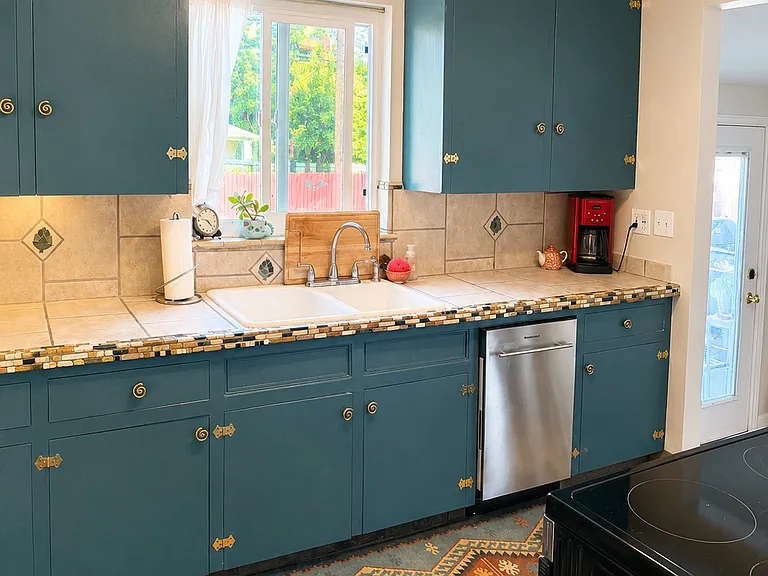 Kitchen with new dishwasher, widow overlooks large backyard