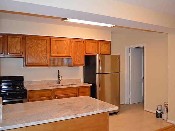 Kitchen with Granite, Stainless Steel Fridge and Fixtures