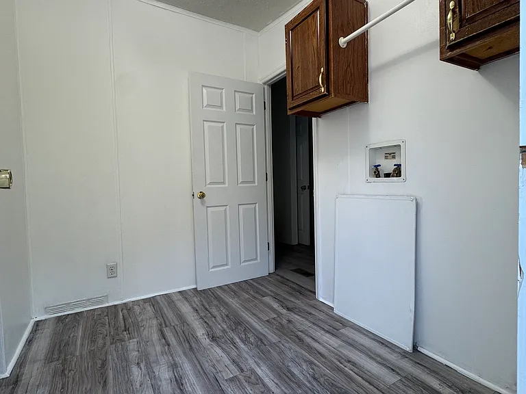Large, freshly painted laundry room with plenty of space for a small chest freezer. opens into master bathroom and kitchen.