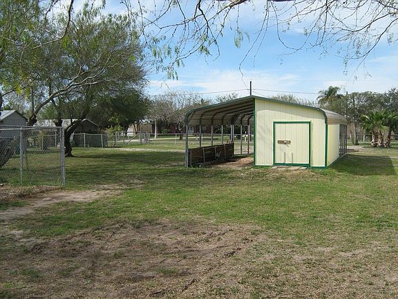 CARPORT, STORAGE, PROPERTY IS COMPLETELY FENCED & SEPARATE DOG RUN