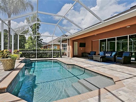 Spacious outdoor entertaining area poolside.  Covered patio, screen lanai and saltwater pool!