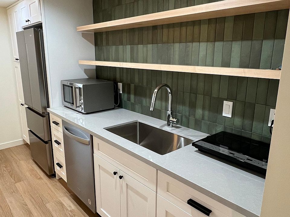 Artisan tile, soft close drawers and cabinets in the designer kitchenette