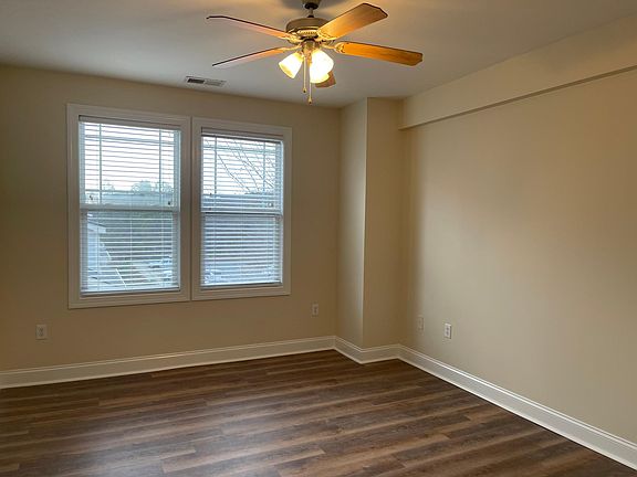 Large master suite with bright windows, new LVP and Hunter ceiling fan