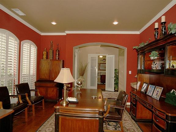 The living room has recessed lighting, crown molding, decorator paint and plantation shutters.