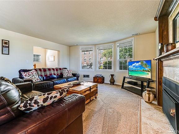 From the foyer, a large living room is on the right with a beautiful bay window overlooking the neighborhood. 