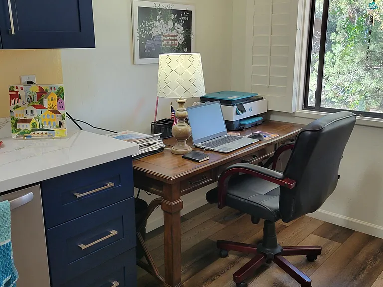 Desk nook in kitchen looking out to woods and bird watching