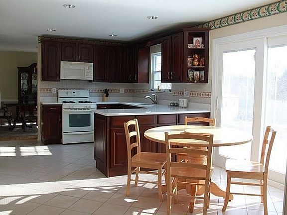 Bright and sunny breakfast area with sliders to a huge patio/backyard