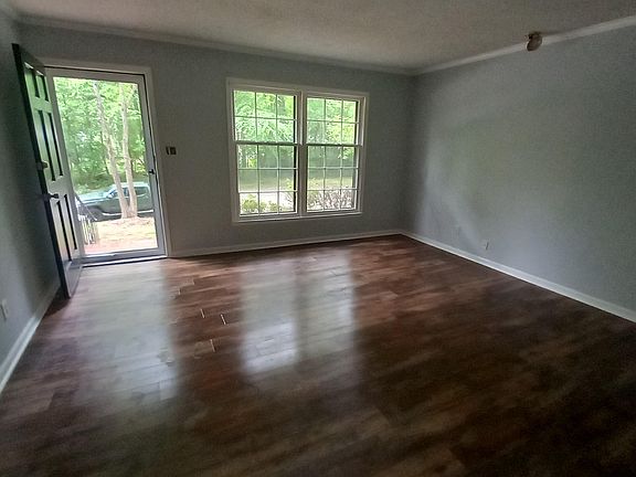 living room with new paint and laminate flooring throughout the house