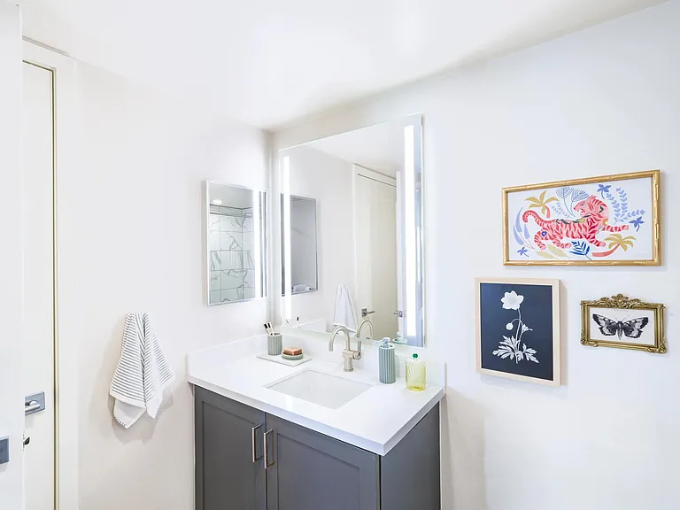 Experience luxury with designer bathrooms featuring quartz countertops and large mirrors!
