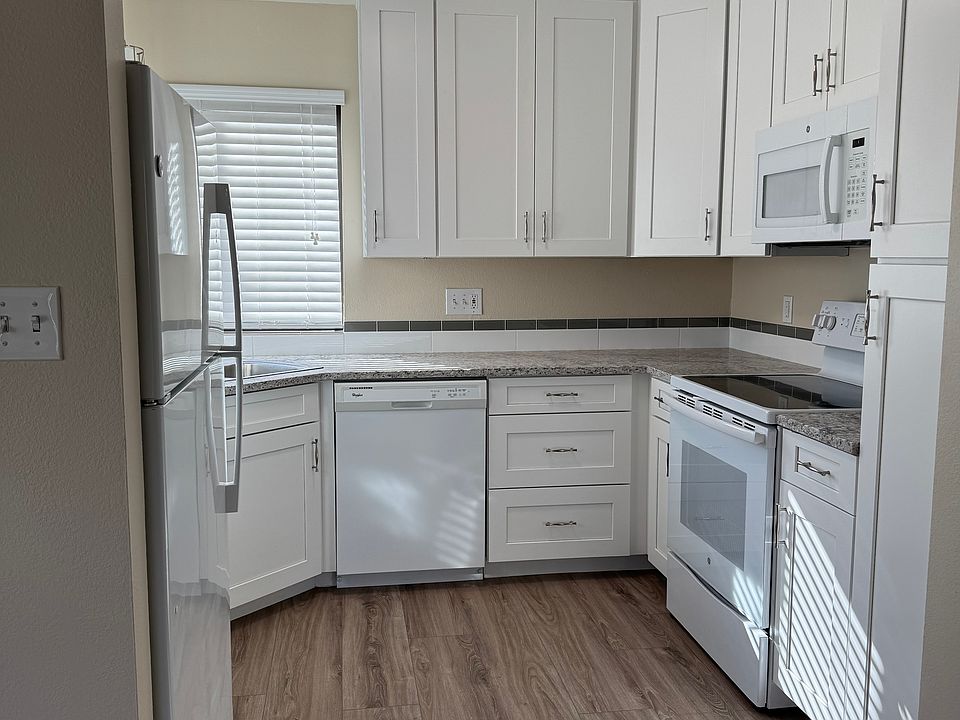 Beautifully remodeled kitchen, quartz countertops, under cabinet lighting, luxury vinyl flooring