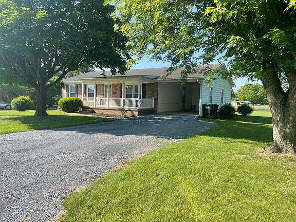 Home offers carport and large driveway.
