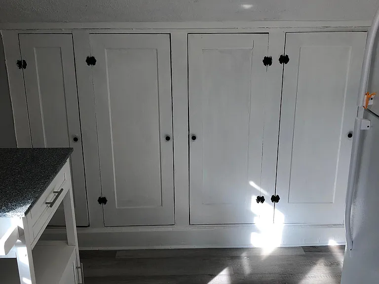 Built in storage cabinets in kitchen with portable kitchen island