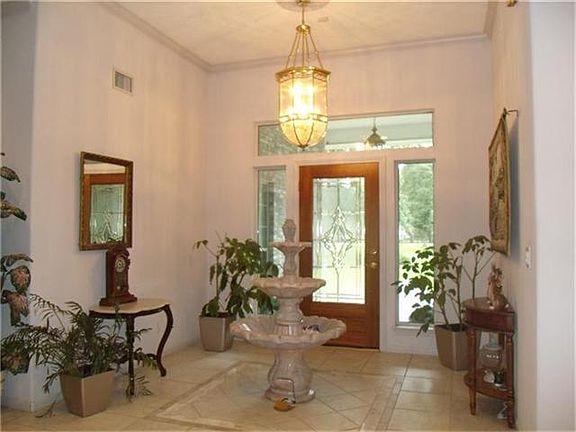 Entry with tile & marble floors. Raised ceilings and crown molding. (Fountain excluded)