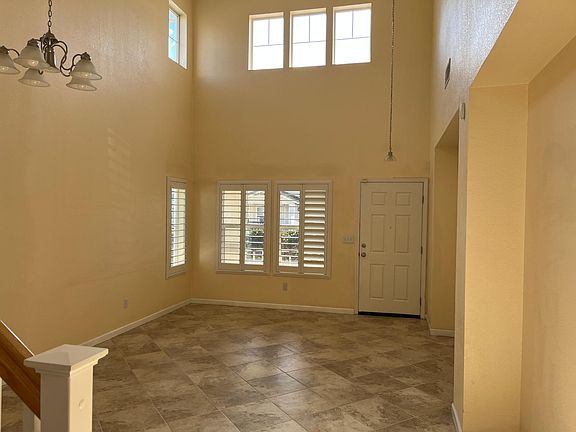 Dining and Living room facing the front door with high ceiling.