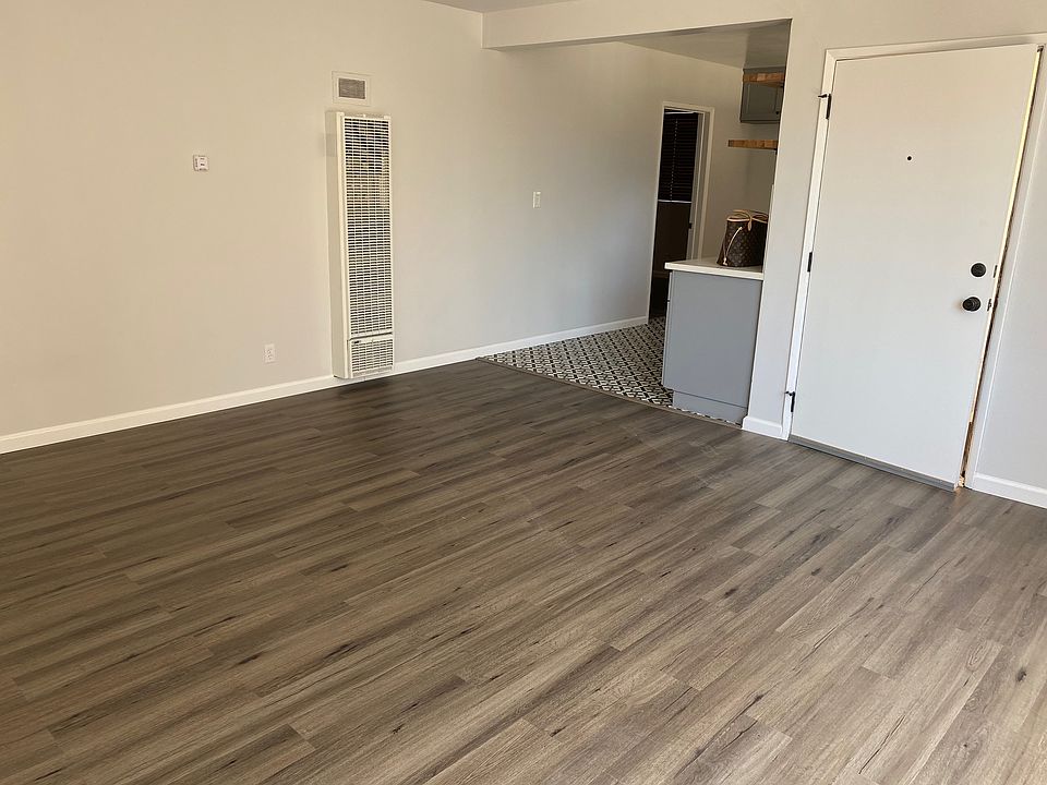 Spacious living area separated by kitchen from bedroom