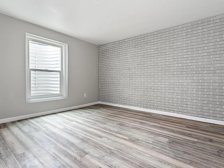 Exposed brick wall in bedroom