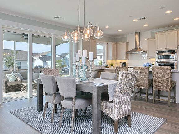 The dining area flows nicely into the kitchen and gathering room, making entertaining a breeze