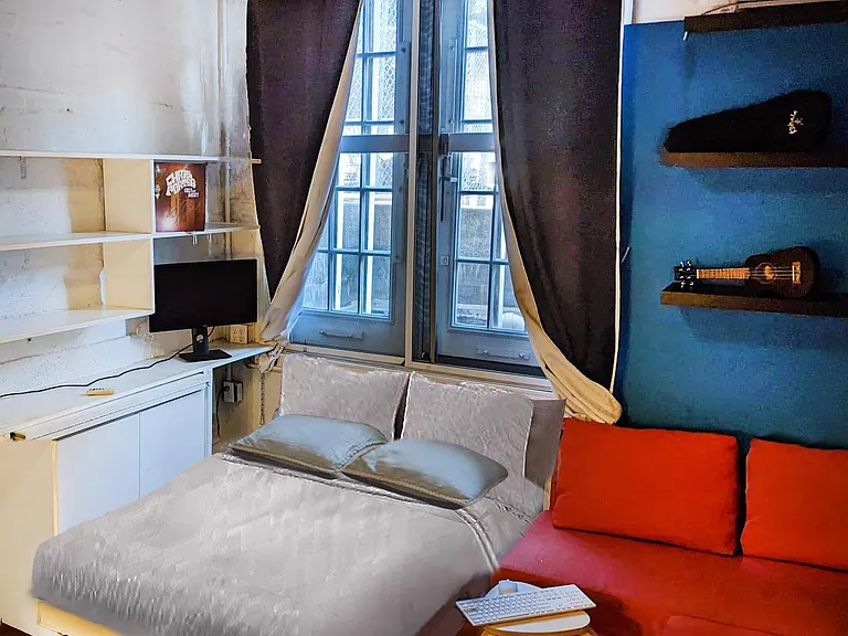 Bed with real mattress easily pulls out and hides away in wall.