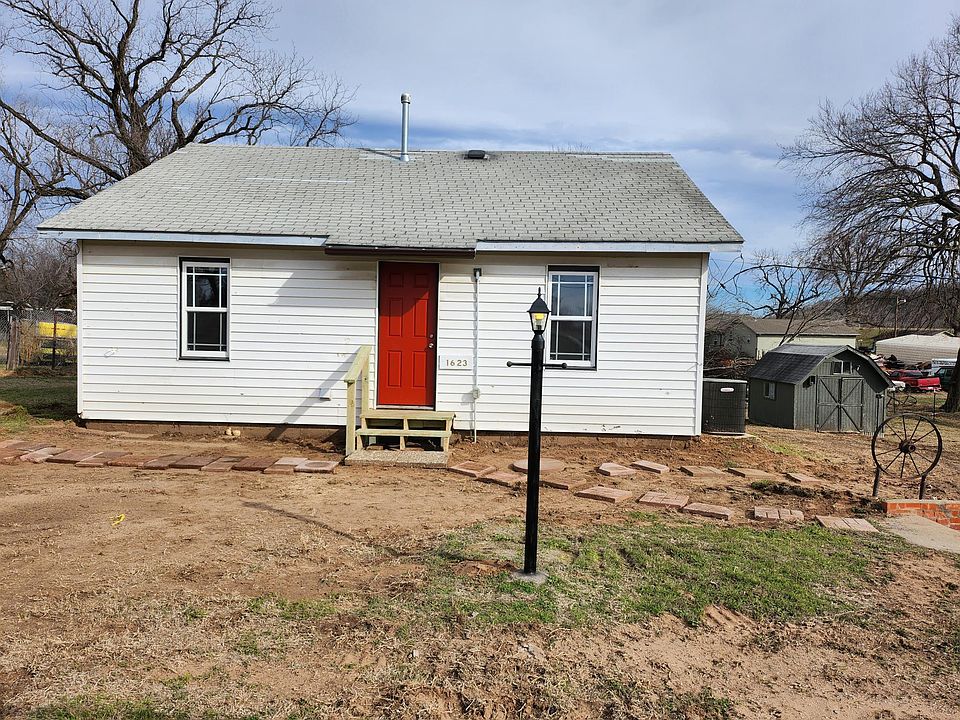 Front of house with 1st shed