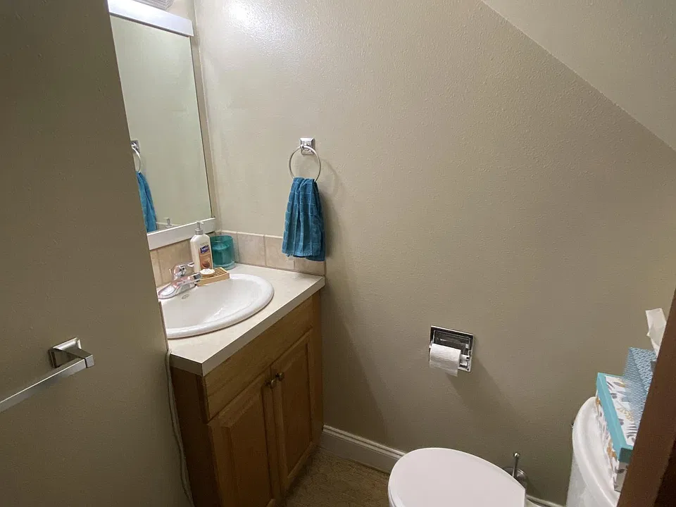 entry level half bath (tucked under the stairs)