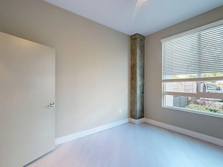 Spacious apartment Bedroom with Wood-Style Flooring.