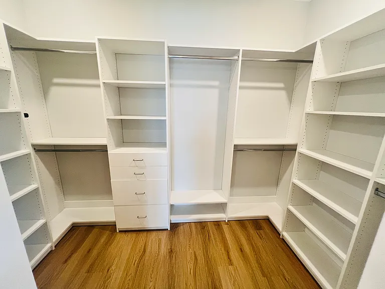 Custom built-in master closet with ample storage and thoughtful design