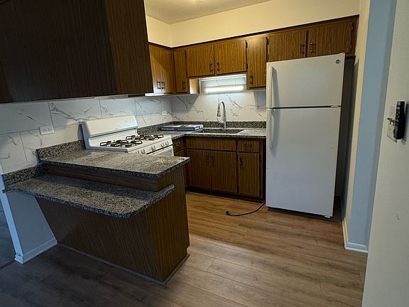 Additional seating at breakfast bar. All new granite countertops and backsplash! Lots of storage.