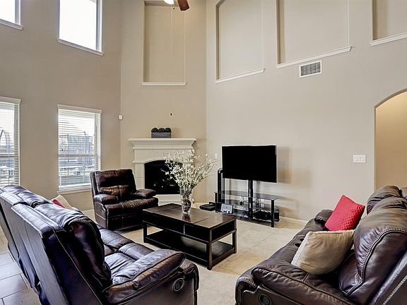 Another view of the family room with the fireplace in the corner.