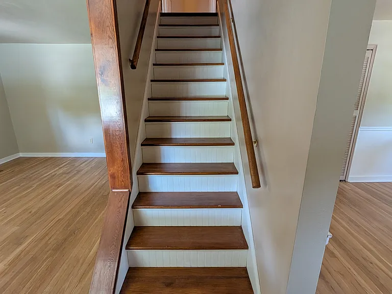 stairs to 2 upstairs bedrooms; living room on the left of the stairs, dining room on the right