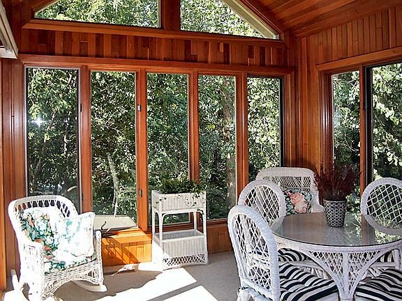 The 4 season porch has floor to ceiling redwood walls 