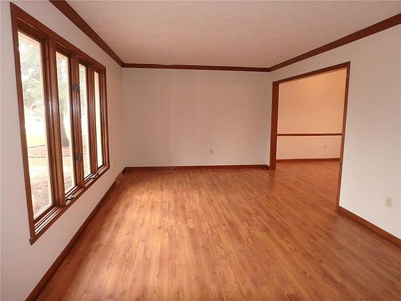 Formal living room with new floors, fresh paint and original crown molding.