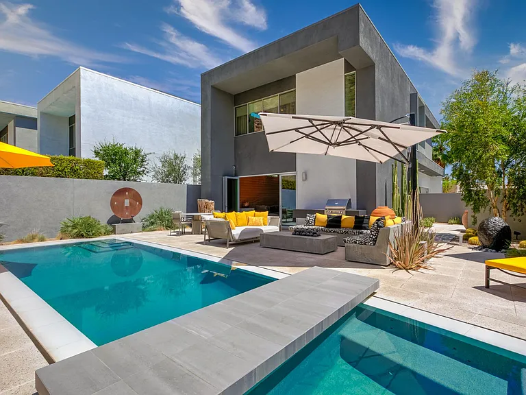 Sunny backyard with shade umbrellas.