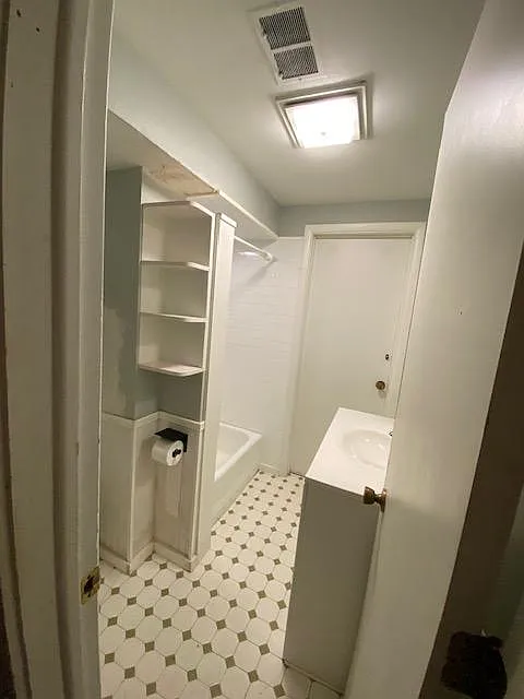 bathroom off the kitchen, separated by a wall/hallway. - 2119 Fairview Ave #1