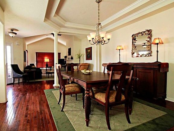 Expansive living room & dining area with vaulted and trey ceilings & gas fireplace, enhanced by the 