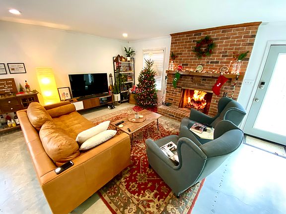 Large wood burning brick fireplace with gas supply.