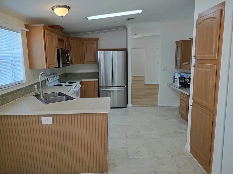 Kitchen photo from breakfast area into living/dining room