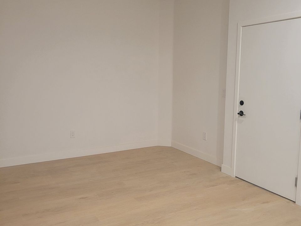 Front door to open concept living, dining, and kitchen