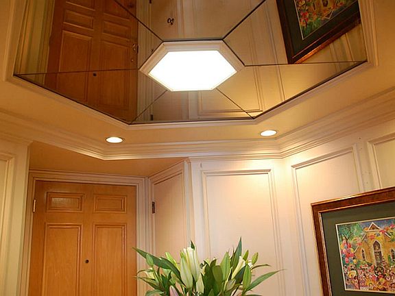 The mirrored ceiling adds to the feeling of space and drama in the foyer.