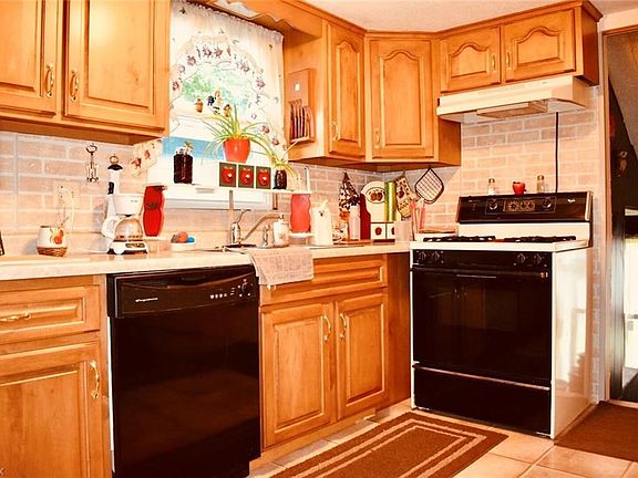 The kitchen cabinets were recently re-faced with the addition of brick-like paneling backsplash.