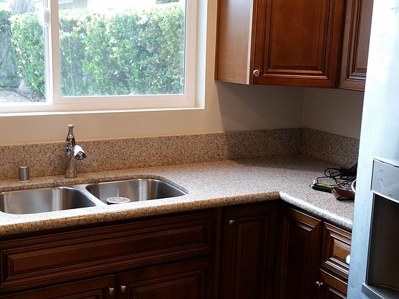 Kitchen sink with lazy susans in both corner cabinets. Nice pull out /spray faucet.