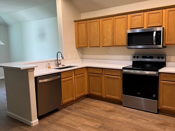 Kitchen with new quartz countertops, new stainless appliances, new sink, new disposal, new faucet, new canned lighting, freshly painted and new LVP flooring