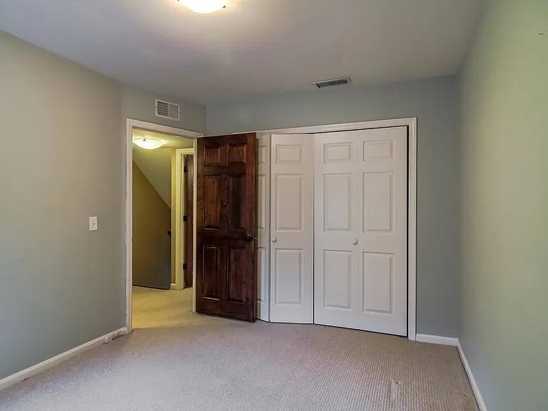rear bedroom with large closet and built-in shelving