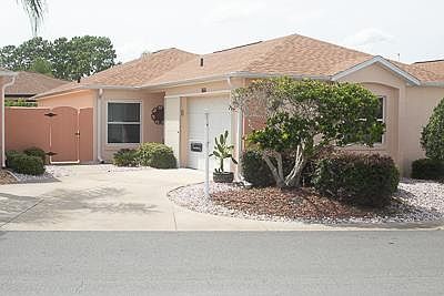 Outside of the recently painted villa; 2 garage door openers; beautiful palm trees next door and an eagles nest that we watched from the front door last year.
