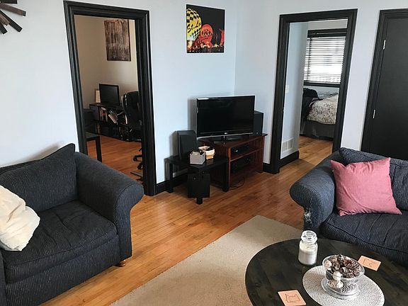 Living room with 2 bedrooms on left.