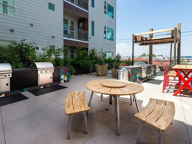 Exterior table and chairs near grilling stations