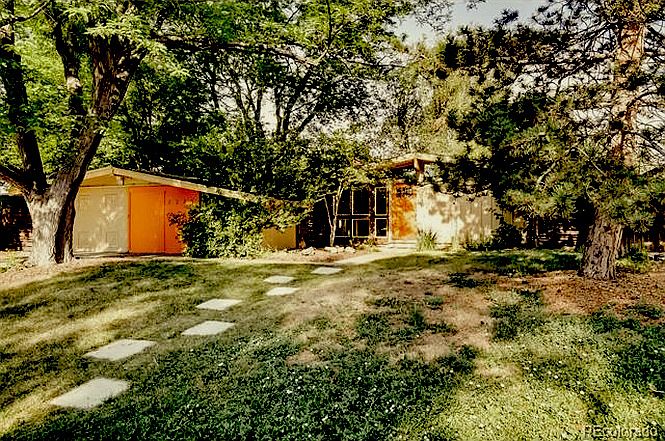 House stands out in the neighborhood with orange color pots and Clifford May styling
, yet is tucked back from street nestled in trees and shade.