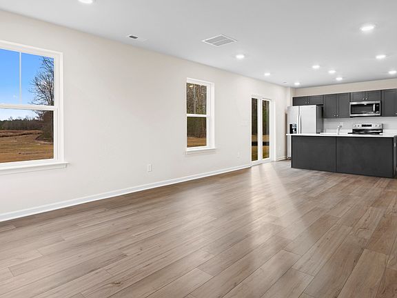 Open 1st floor living room and kitchen in a DRB Homes Glenshaw plan at The Village of College Park.