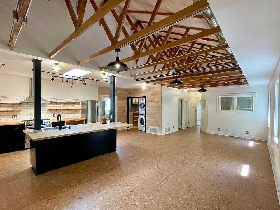 Vaulted wood ceilings with an open floor plan for entry, kitchen, living, laundry, and dining area. Eco-friendly cork flooring throughout.