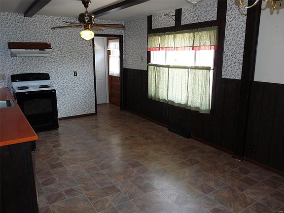 Open eat in kitchen with entry to garage and deck.